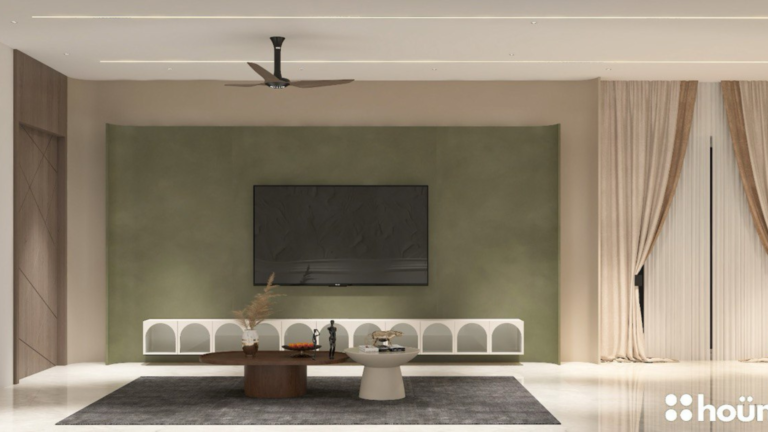 A contemporary living room design featuring a stylish blue glass partition separating the dining area, as showcased on Houme India's website. C
