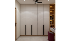 A well-lit walk-in closet with built-in wardrobes, a vanity table, and a plush stool. B
