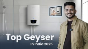 Ar. Sourabh Jain is in a black blazer smiling and gesturing towards a modern white electric geyser (water heater) mounted on a tiled bathroom wall. A small inset image shows a person showering. The title reads "Top Geyser In India 2025.