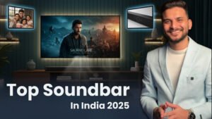 Ar. Sourabh Jain is in a blazer smiling and gesturing towards a modern soundbar placed beneath a large screen displaying an audio equalizer visual. Smaller inset images show a soundbar on a table and a hand holding a soundbar remote. The title reads "Top Soundbar In India 2025.