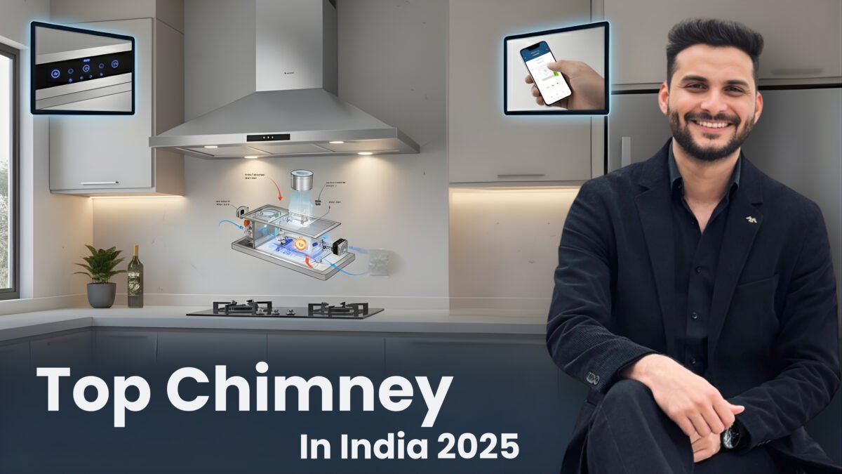 A modern kitchen chimney in a sleek silver finish installed above a hob, with a diagram of its internal workings (suction and auto-clean technology) floating above. A confident man (Sourabh) in a black suit points to the chimney, with the title "Top Kitchen Chimney In India 2025" clearly visible at the bottom. The background is a sophisticated, clean kitchen with grey and white cabinets.